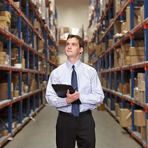 Man in library isle holding a book