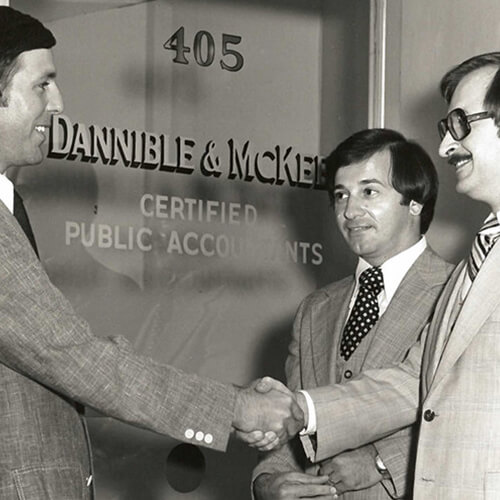 Founders, Anthony Dannible and Lance McKee shaking hands in front of CPA office