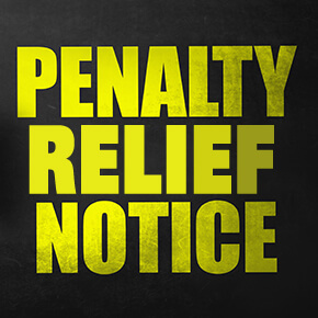 Black box with yellow words saying penalty relief notice written on it