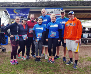Partners and staff of Dannible & McKee posing for a picture after running in a charity event