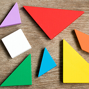 Straggled tangram puzzle wait to complete the shape on wood background