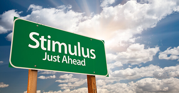 Stimulus Green Road Sign with Dramatic Clouds, Sun Rays and Sky.