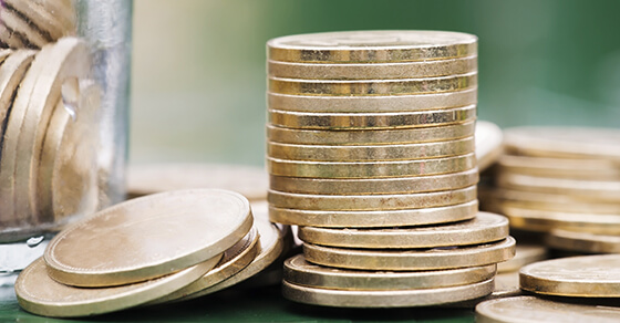 Gold money stacked coins with jar