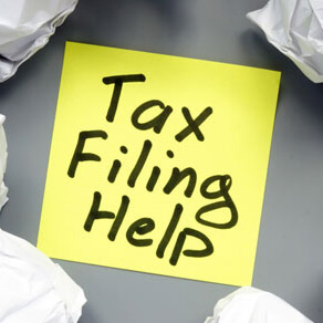 Sticky note with words tax filling help