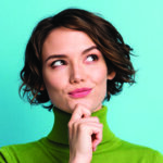 Close up of a women with her hand on her chin as she looks up