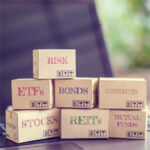 Boxes stacked on top of each other with the financial words on them including "Risk," "EFT," "Bonds"