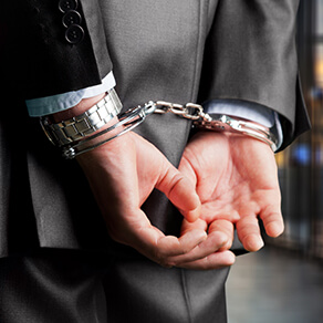 Close up of businessman's hands in handcuffs