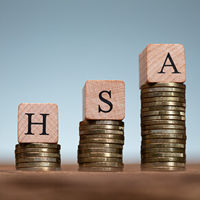 HSA Health Savings Account Wooden Blocks On Coin Stacks