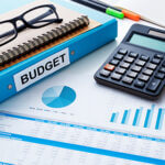 Financial and budget planning concept with calculator notebook and financial chart report on work desk