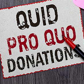 The words "Quid Pro Quo Donations" written with a marker laying on top