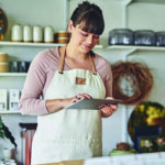 Waitress/ store owner taking an order on a tablet