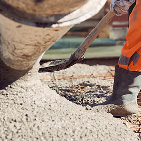 Photo of a construction worker's hand poring cement
