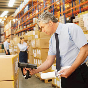 Person using a barcode scanner to scan packages
