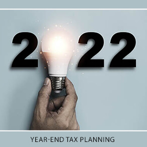 The date 2022 with a hand holding a light bulb making up the