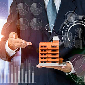 Business man pointing to model of an apartment complex in his hand with overlay of graphic charts