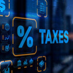 The percent sign and word "taxes" on a digital screen with graphics