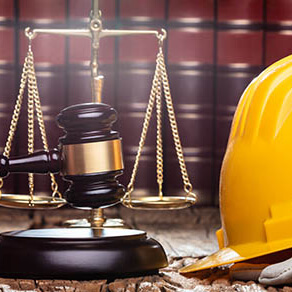 Court room gavel, scale, and books with a construction hat