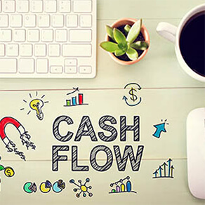 Drawing that reads "cash flow" with a computer keyboard, coffee cup, mouse, and other items on a desk