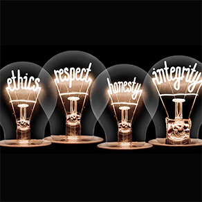 Photo of light bulbs with shining fibres in ETHICS, RESPECT, HONESTY and INTEGRITY shape isolated on black background