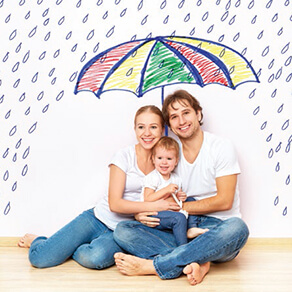 Mother, father and baby sitting on the floor under a cartoon umbrella with raindrops