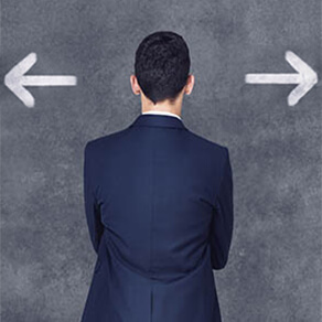 Man in suit facing backwards with arrows by his head in opposite directions
