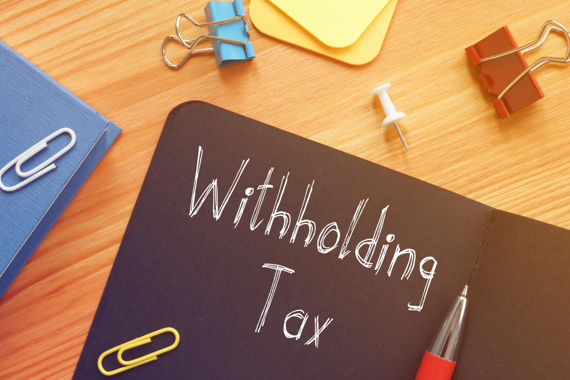 Withholding Tax is shown on the conceptual business photo