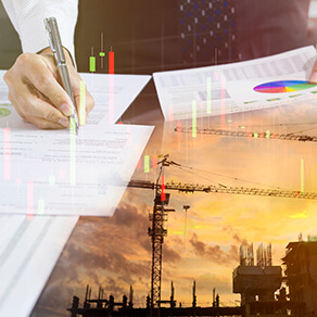 Businessman signing on a building construction contract with construction site reflection on foreground.