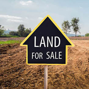 and for sale sign against trimmed lawn background. Empty dry cracked swamp reclamation soil, land plot for housing construction project in rural area and beautiful blue sky with fresh air.