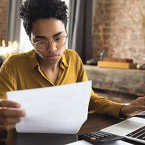 Woman at a desk looking over a document