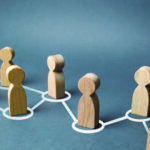 Wooden figures in an off center row