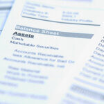 Financial documents with focus on a word "Assets. Very easy to shift colors.