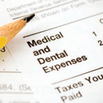 Medical and dental expenses paperwork with a pencil