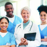 Group of doctors and medical professionals standing together smiling