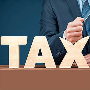 Tax reduction business and financial concept. Angry businessman try to destroy text tax.