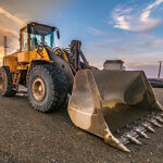 Excavator at the end of a working day at a construction site in a beautiful evening