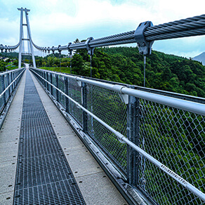 Long bridge heading towards hills