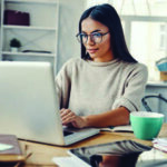 Woman working from a home office on her laptop
