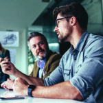 Two men in discussion at a table