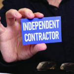 Close up of someone holding a business card reading "Independent Contractor"
