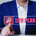 Close up of a man hitting a button that reads, "529 Plan"