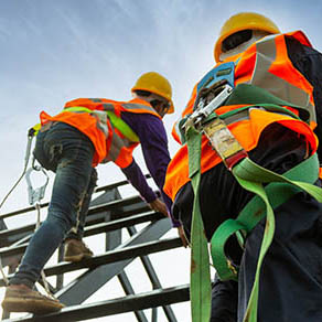 worker with hooks for safety body harness on the roof structure