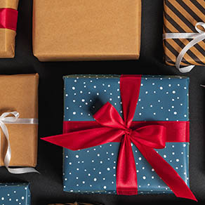 Christmas gift boxes with ribbon and bows on black background