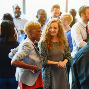 A group of people mingling at a professional event