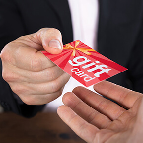 Someone giving another person a gift card