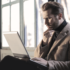 Man with computer thinking