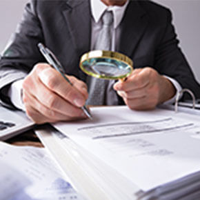 Man with magnifying glass investigating Innocent Spouse Rules