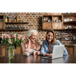 Mother and daughter looking at computer smiling