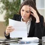 Woman looking at papers intensely