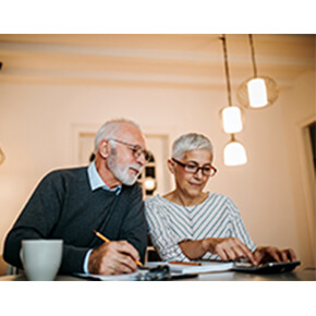 Elderly couple looking at papers and calculator
