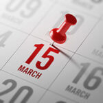 Calendar with March 15 written in Red with Red tack